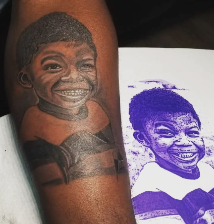 image of a tattoo of someone's son on their arm
